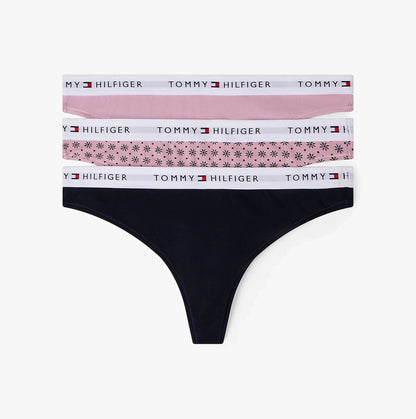 Black thong with floral and solid color waistbands on a white background, featuring Tommy Hilfiger branding.
