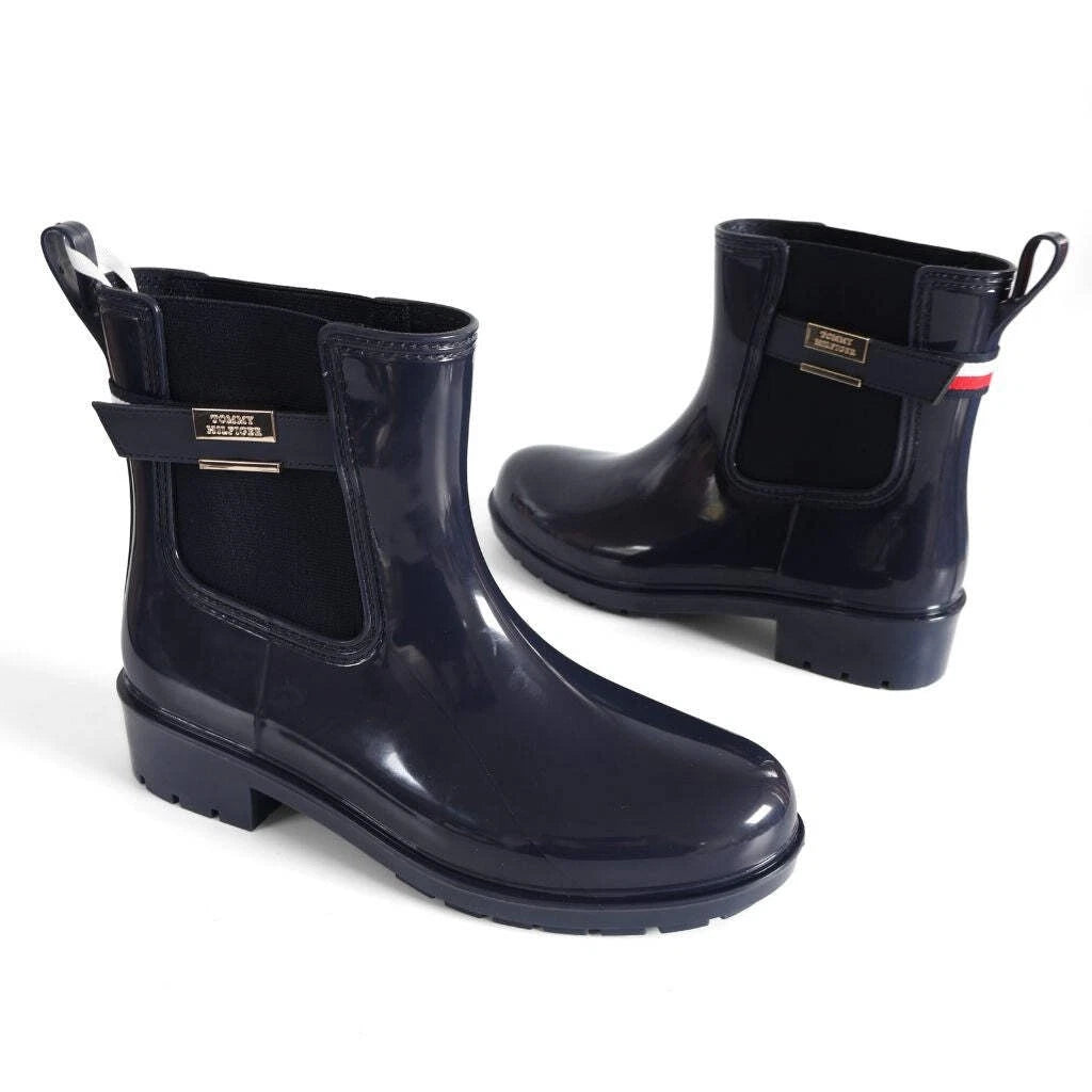 Tommy Hilfiger Women’s Flag Belt Rainboots in Space Blue. Waterproof, stylish & durable for any weather. Shop now at New, Used and More!