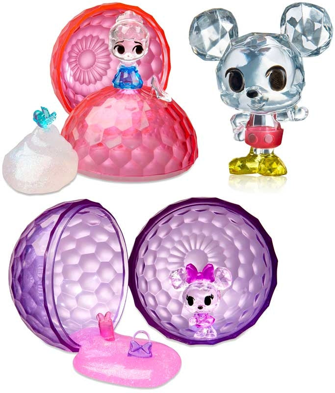 Set of colorful toys with transparent figures inside spherical containers on a white background