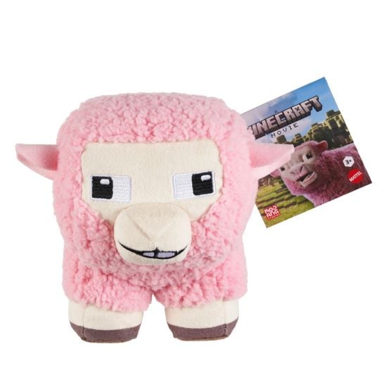 Pink plush toy resembling a sheep from Minecraft with a promotional card in the background.