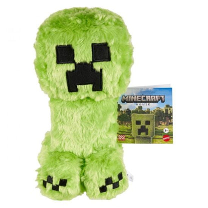 Green plush toy resembling a Minecraft character with a Minecraft-themed packaging on a white background.