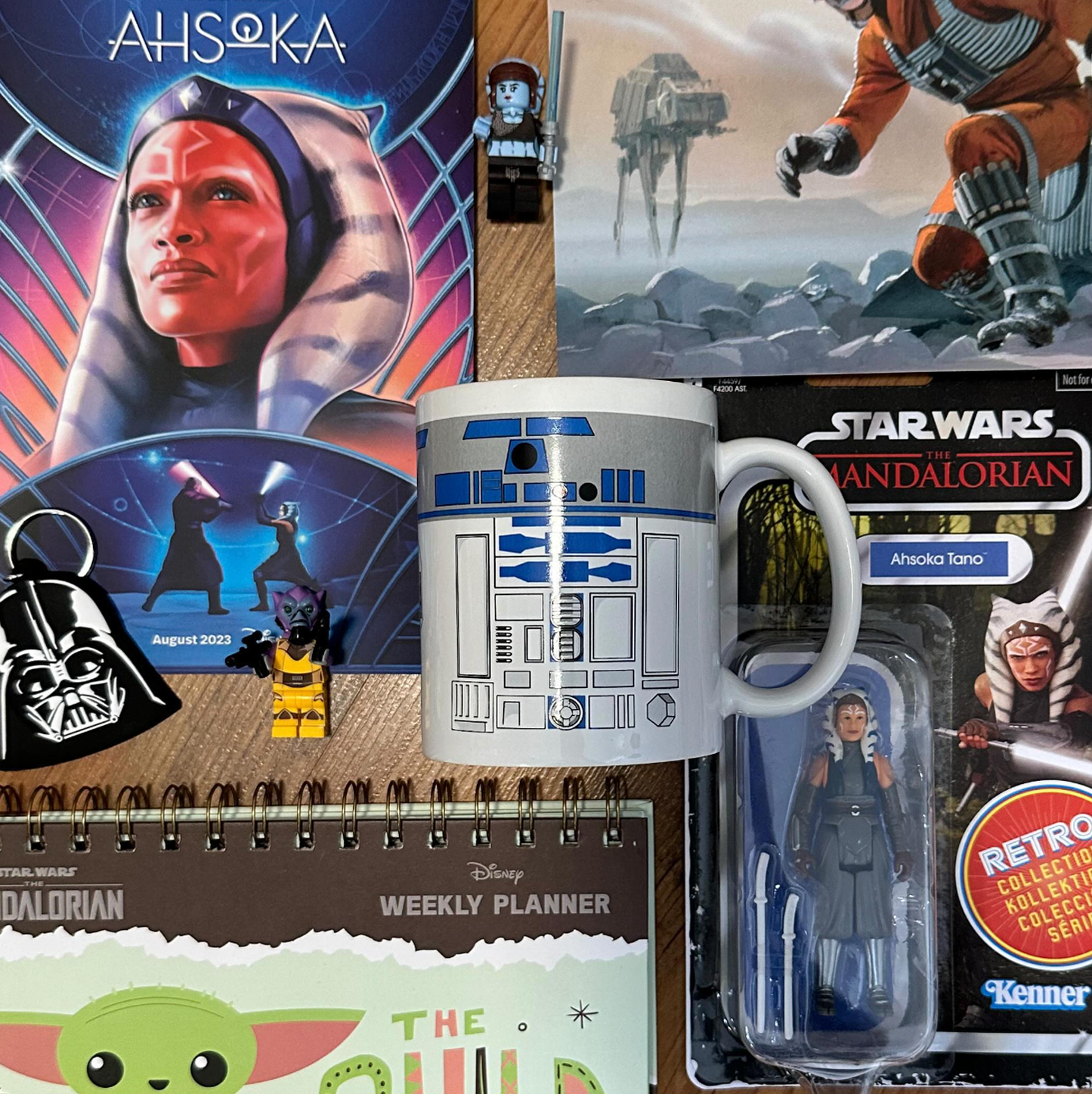 Collection of Star Wars merchandise including a mug, action figure, and planner.