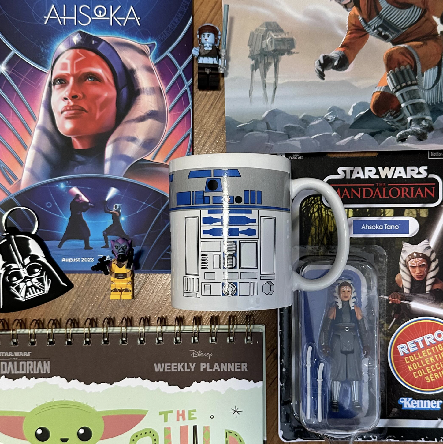 Collection of Star Wars merchandise including a mug, action figure, and planner.