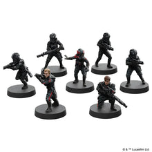Set of six miniature figures on stands against a white background