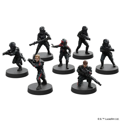 Set of six miniature figures on stands against a white background