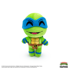 Plush toy of a green turtle character with blue mask on a white background