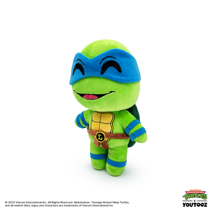 Plush toy of a green turtle character with blue mask and bandages on a white background