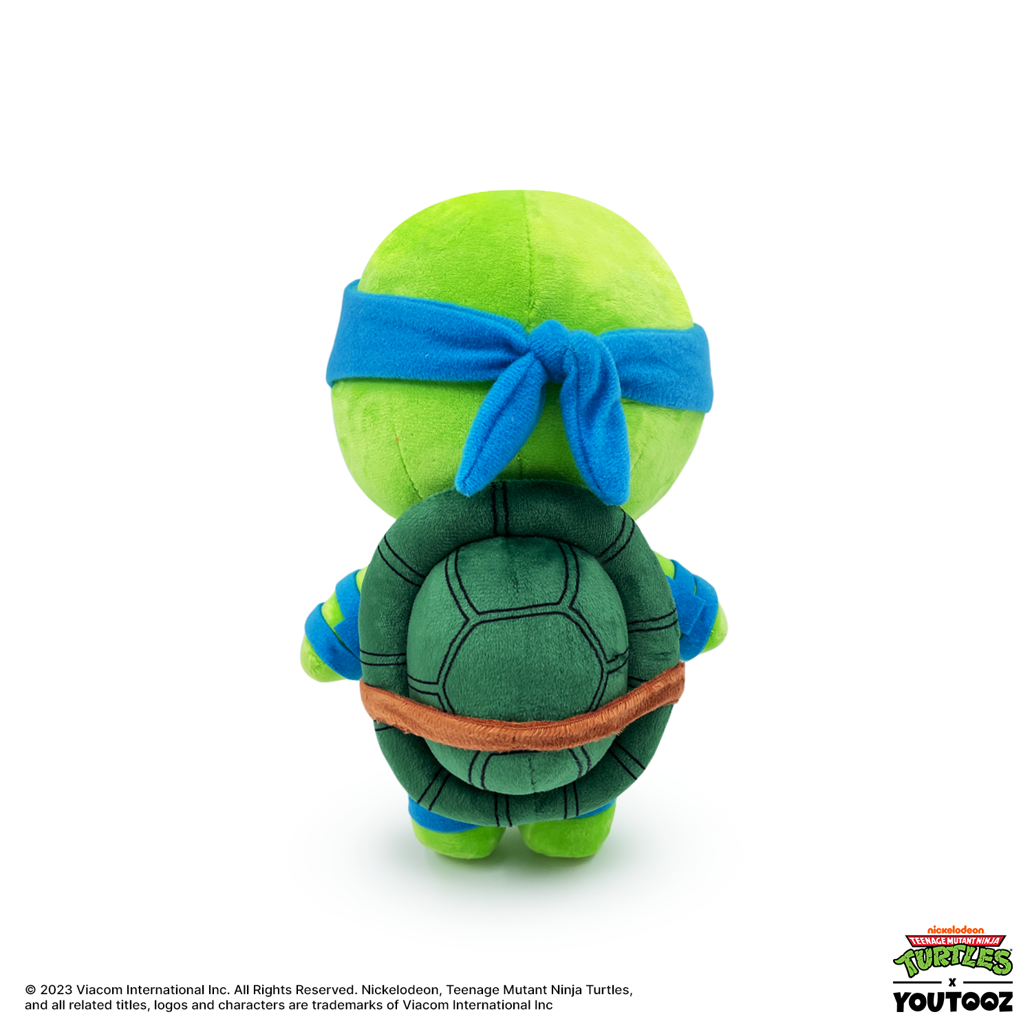 Plush toy of a green turtle with a blue headband on a white background