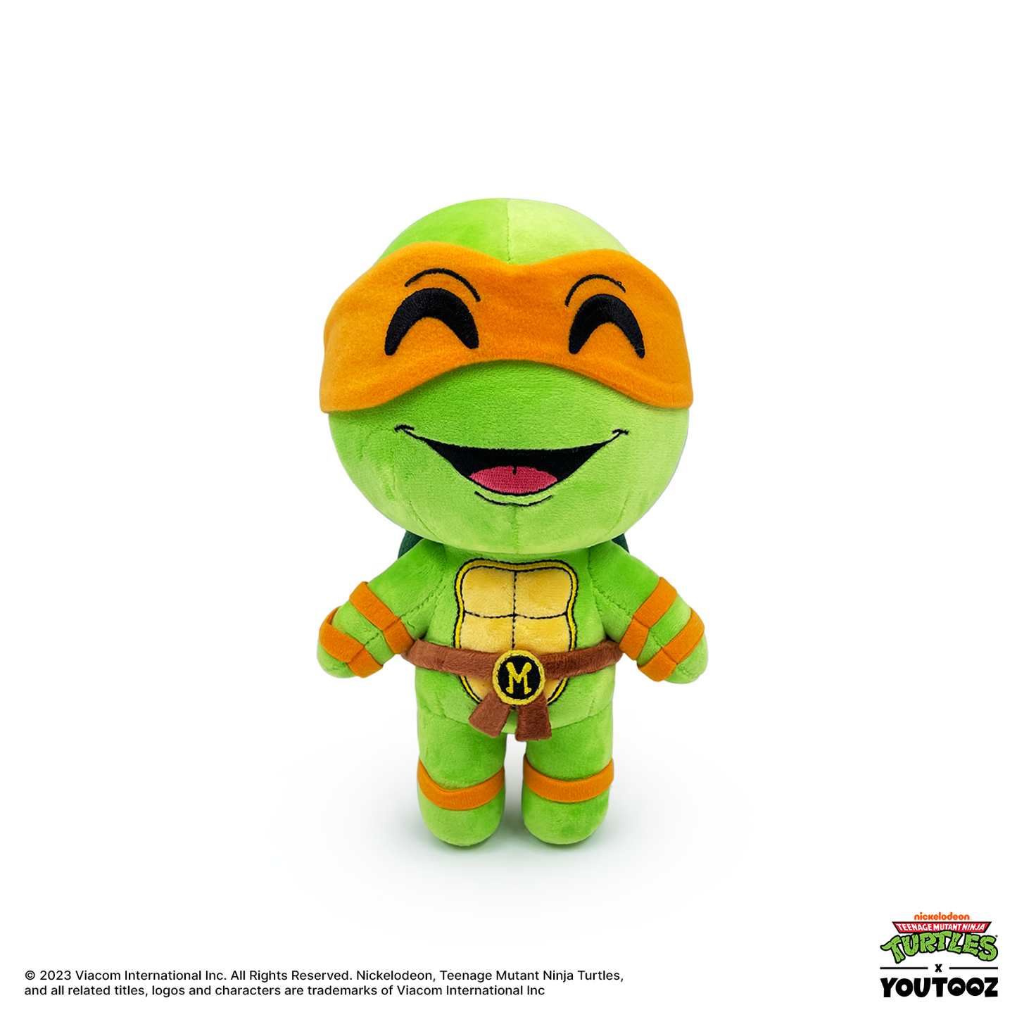 Plush toy of a green turtle character with orange mask and belt on a white background