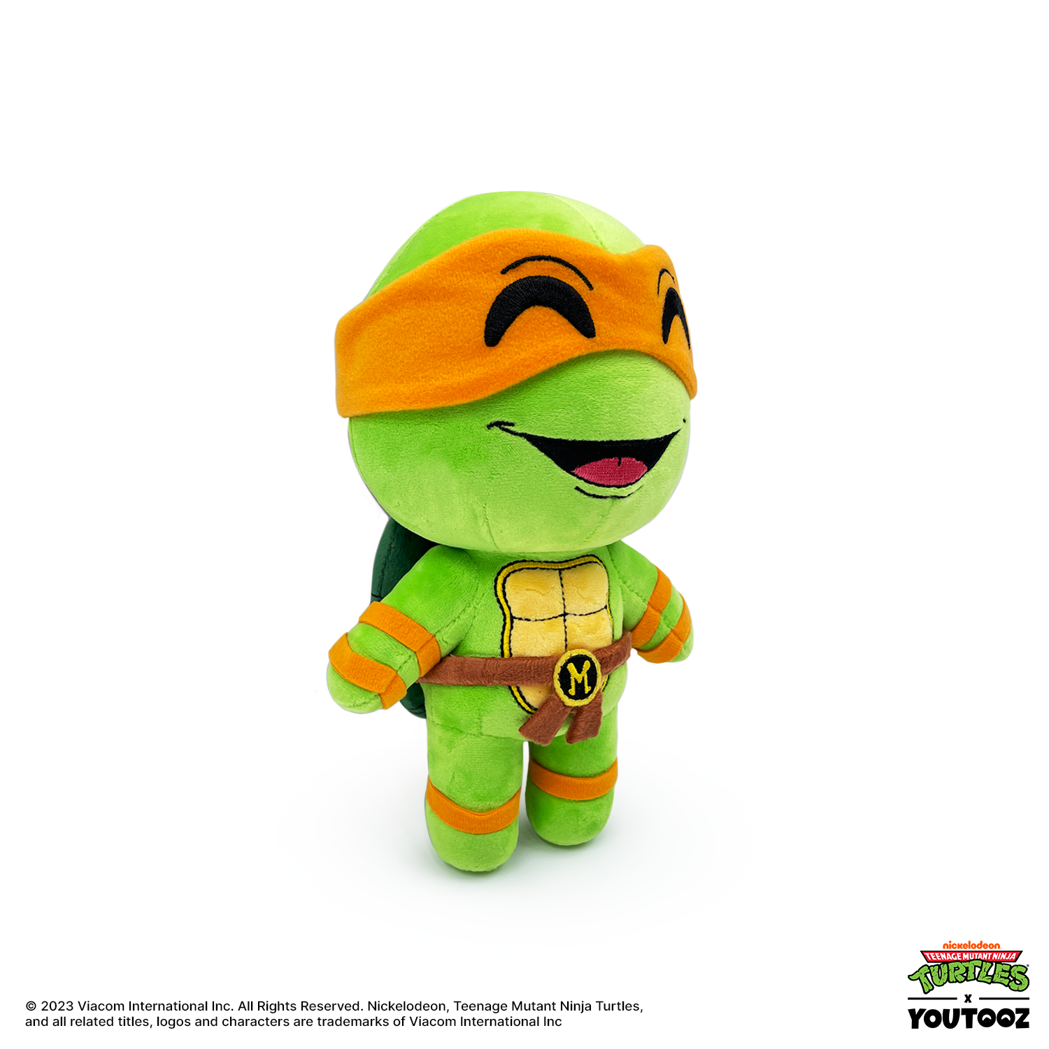 Plush toy of a green turtle character with orange headband and belt on a white background