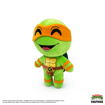 Plush toy of a green turtle character with orange mask and bandages on a white background