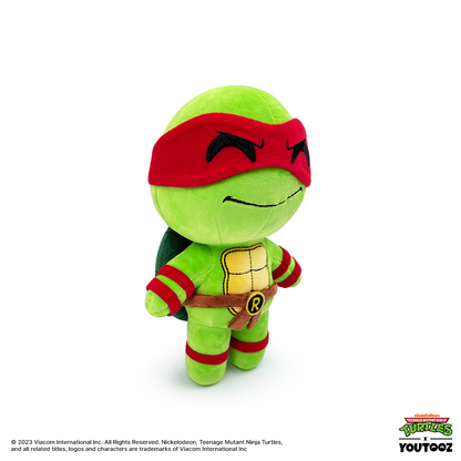 Plush toy of a green turtle character with red mask and bandages on a white background