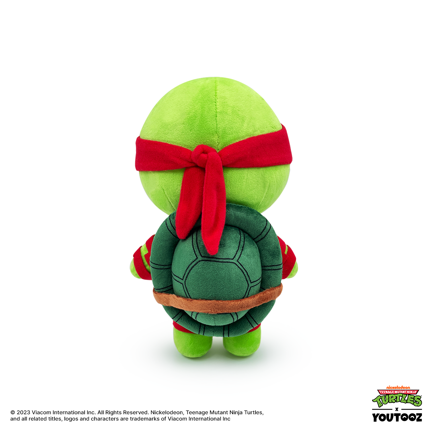 Plush toy of a green turtle with a red bandana on a white background